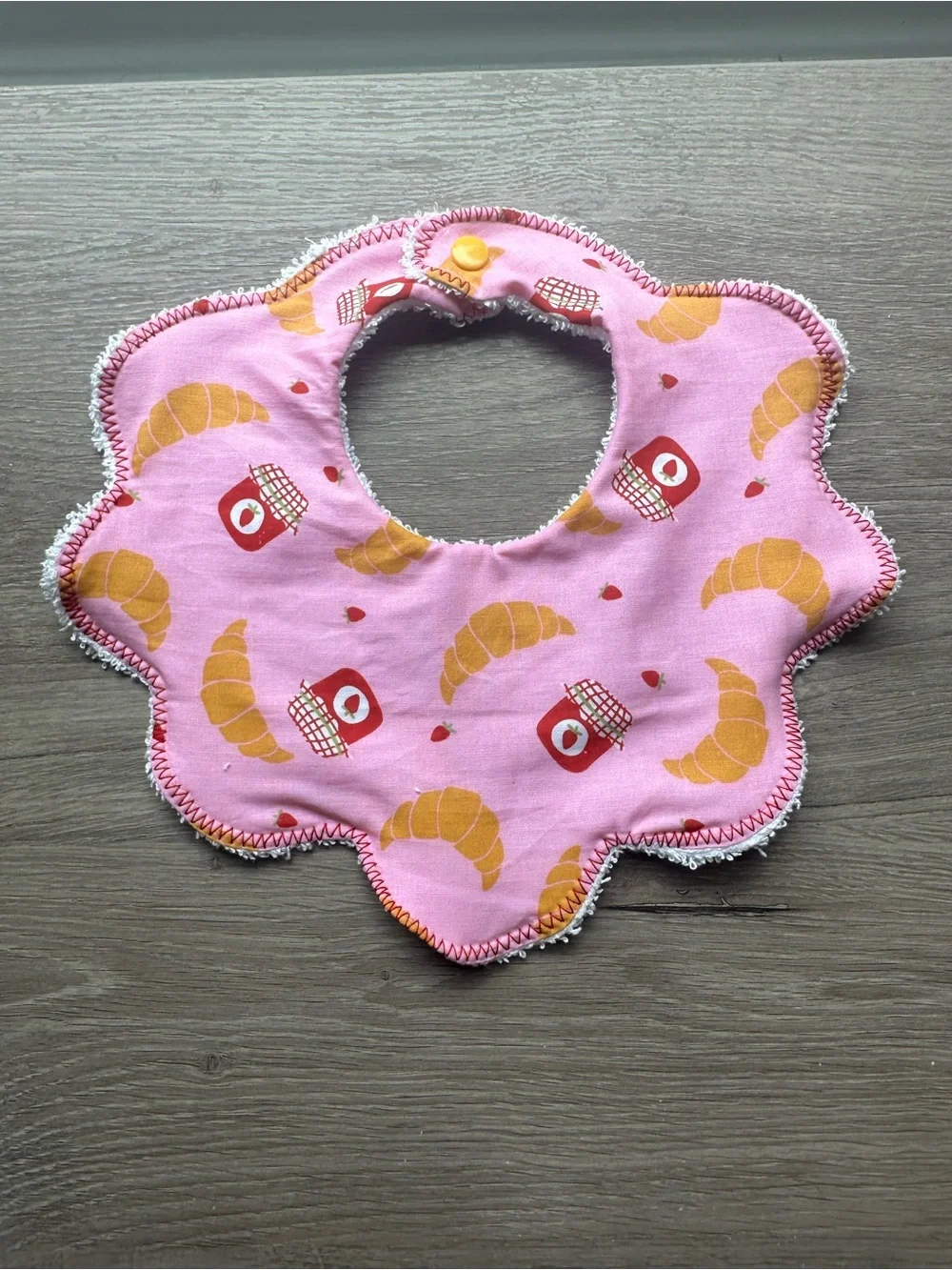 Pink Flower-Edge Baby Bib with Croissant & Jam Print